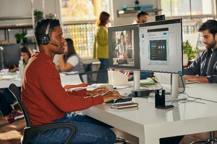 Man at desk with 2 monitors